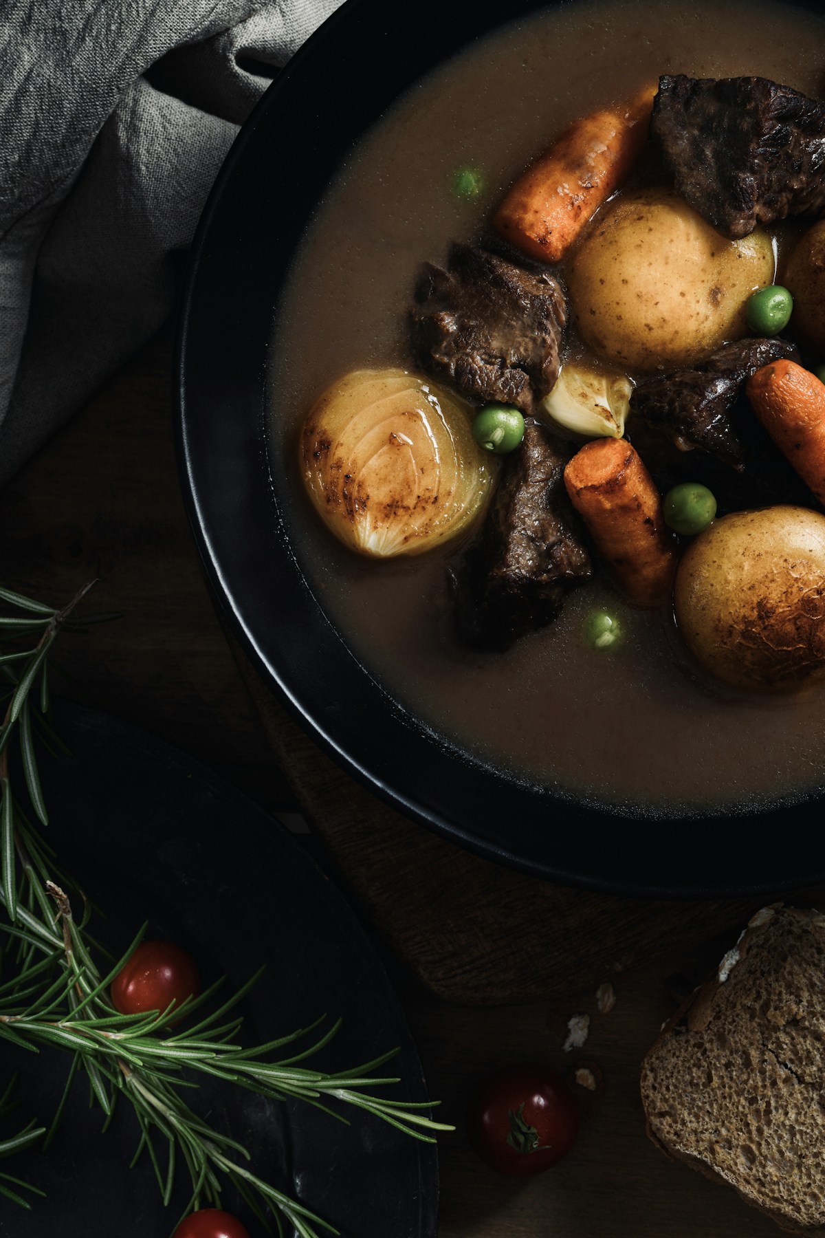 Tender slow cooker beef pot roast with carrots, baby potatoes, and rich brown gravy in a serving bowl