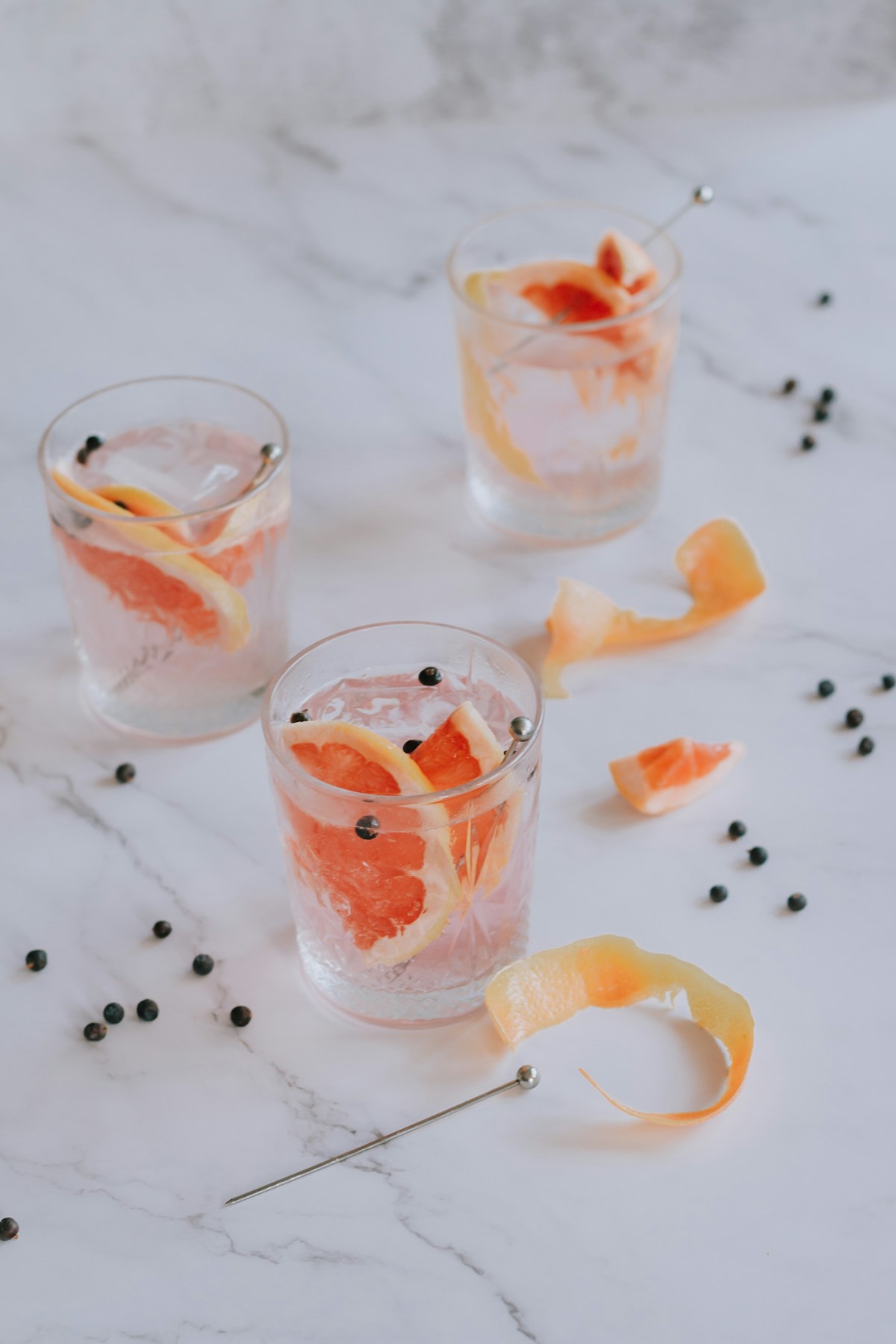 A glass of pink gelatin trick weight loss tonic with fresh lemon slices and unflavored collagen gelatin